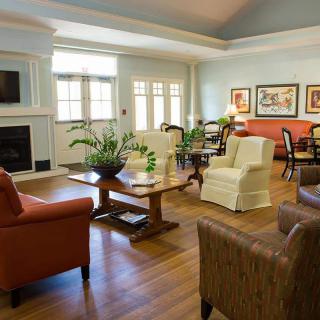 A cozy living room with a mix of comfortable seating and natural light.