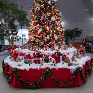 A beautifully decorated Christmas tree surrounded by festive decorations.