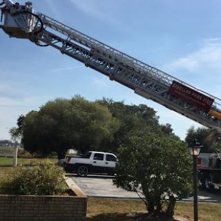 A fire truck extends its ladder towards the sky, ready for action.