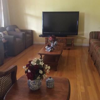 A cozy living room with a large television and comfortable seating.