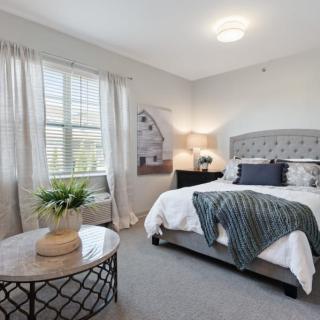 A modern and tastefully decorated bedroom with a large bed, bedside tables, and stylish decor.
