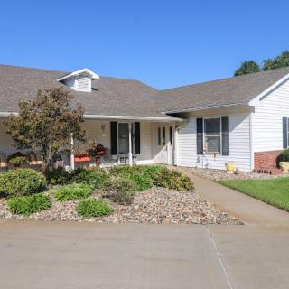 A suburban house with a landscaped front yard and driveway.