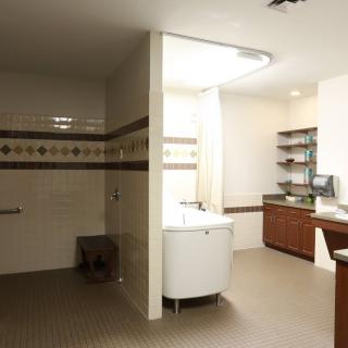 A modern bathroom interior featuring a sink, wooden cabinets, and well-designed lighting.