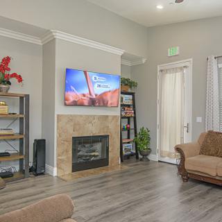 A cozy living room with a fireplace, television, and comfortable seating.