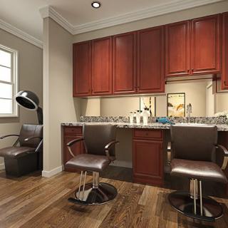 A cozy hair salon interior with two styling chairs, mirrors, and wooden cabinets.