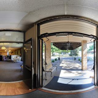 A panoramic view of an entrance leading to an outdoor area, showcasing the transition from indoors to outdoors.