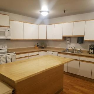 A spacious kitchen with wooden cabinets and a central island.