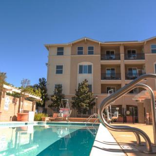 A residential apartment building with an outdoor swimming pool.