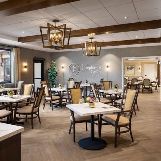 A modern and stylish restaurant dining room with neatly arranged tables and chairs.