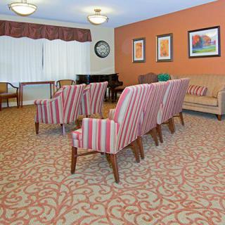 A cozy lounge area with striped chairs and warm decor.