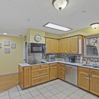 A cozy kitchen with wooden cabinets and modern appliances.