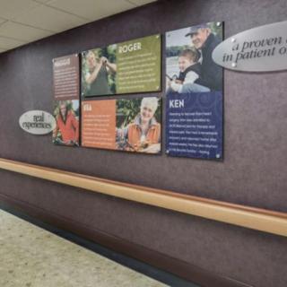 A hospital hallway featuring informational posters and wall art.