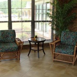 A cozy seating area with two chairs and a small table near a large window.