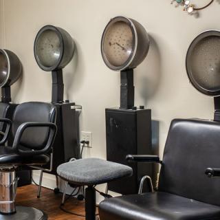 Vintage salon interior with classic hair dryers and chairs.