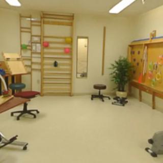 A rehabilitation room equipped with various physical therapy and exercise tools.
