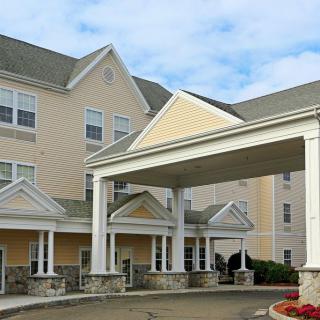 A modern hotel exterior featuring a covered entrance.