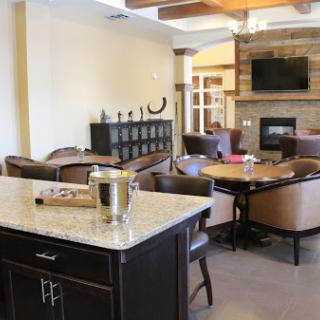 A cozy and modern living room featuring a fireplace, comfortable seating, and an inviting dining area.