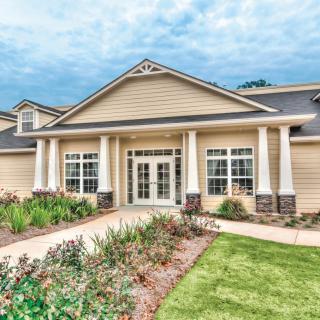 A beautiful house with a landscaped garden and classic architectural features.