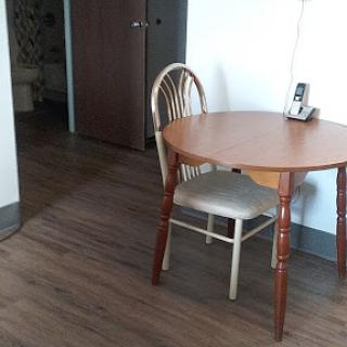 A cozy dining setup featuring a wooden table and chairs.
