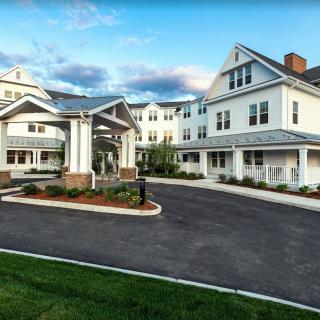 A large residential building with a welcoming entrance and driveway.