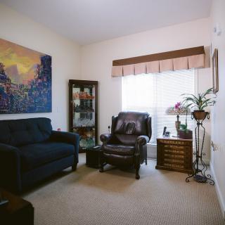 A cozy living room featuring a sofa, armchair, and decorative items.