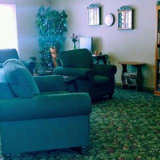 A cozy living room with comfortable seating and decorative elements.