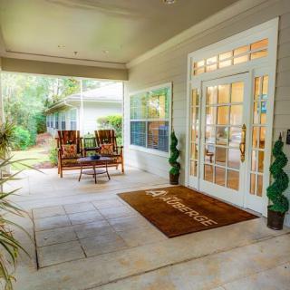 A welcoming porch with comfortable seating and decorative plants.