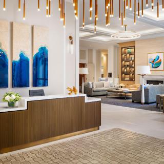 A modern and luxurious hotel lobby with elegant decor and contemporary artwork.