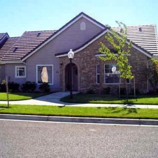 A charming suburban house with a well-kept front yard and elegant architecture.