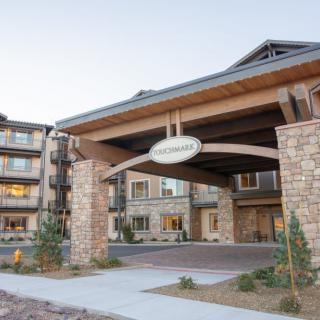 A luxurious hotel entrance with a stone facade and modern architectural design.