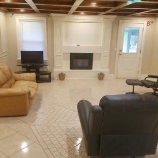 A cozy living room with a fireplace, television, and comfortable seating.