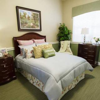 A cozy bedroom with a neatly made bed and stylish decor.