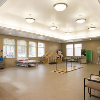 A spacious rehabilitation therapy room equipped for patient exercises and recovery.
