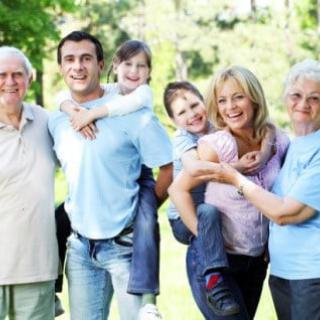A happy family of multiple generations enjoying time together outdoors.