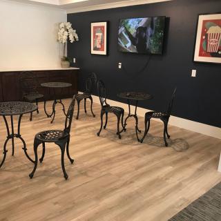 A cozy seating area with ornate metal chairs, small tables, and elegant decor.