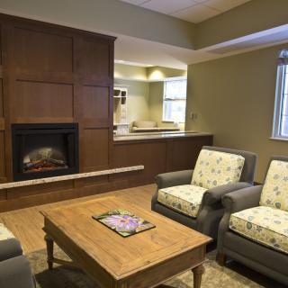 A cozy living room with a fireplace and comfortable seating arrangement.