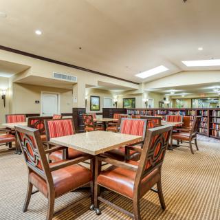 An empty dining area with neatly arranged tables and chairs.