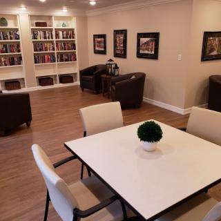 A modern reading room with bookshelves and seating area.
