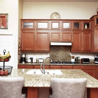 Modern kitchen with wooden cabinets and a granite countertop.