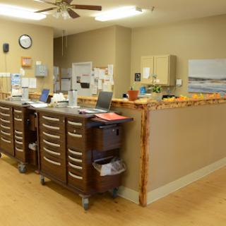 A well-organized medical office reception area with cabinets and computers.