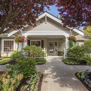 A charming house with a well-maintained front yard and beautiful landscaping.