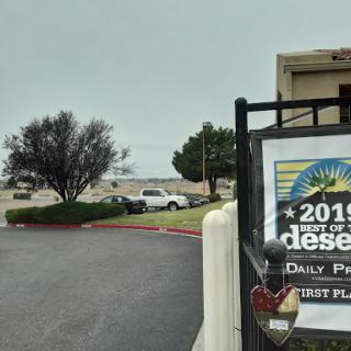 A view of a desert area with cloudy skies and a sign indicating the year.