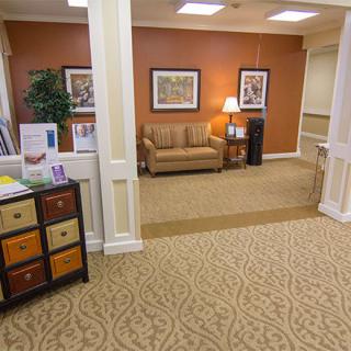 A cozy waiting area with a sofa and warm decor.