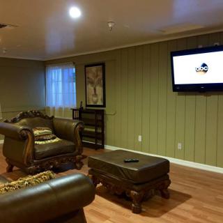 A cozy living room with comfortable seating, a wall-mounted television, and stylish decor.