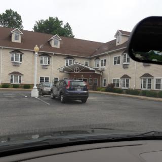 A view of a hotel from the parking lot.