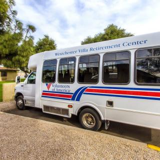 A community shuttle bus parked outdoors, ready for service.