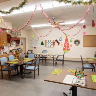 A festive classroom decorated with Christmas decorations, including garlands and various holiday-themed artwork on the walls.