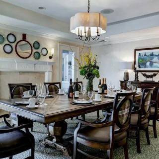 A beautifully decorated dining room with a large table and elegant furnishings.