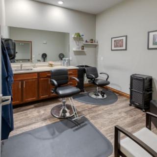 A modern hair salon interior with styling chairs and mirrors.