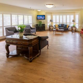 A bright and inviting living room space featuring comfortable seating and ample natural light.